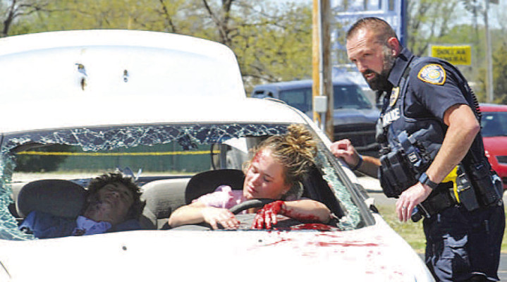 Clearwater High School students learned about the dangers of driving while intoxicated during a realistic demonstration of what a crash involving a drunk driver looks like. The demonstration included Clearwater police and fire personnel, as well as first responders from other agencies. In this photo, Clearwater school resource officer Justin Jacks checks on the driver, played by Elizabeth Tjaden. Ty Cash is the passenger. Dale Stelz/TSnews
