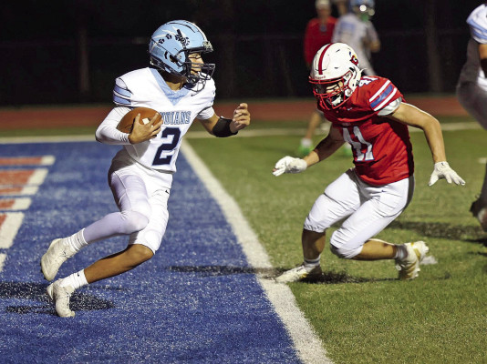 Clearwater quarterback Talen Tjaden tries to find some running room as Cheney defender Colton Veach closes in during the Cardinals’ shutout victory over the visiting Indians.