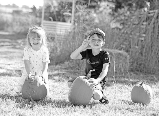 Lucy and Westen Ruddick have fun at the pumpkin patch Floyd's Fall Fest, held on Saturday at Souders Historic Farm Museum near Cheney. The festival celebrates the legacy of Floyd Souders, who co-founded and ran the museum with his wife, Norma. Stephanie McKennon/TSnews