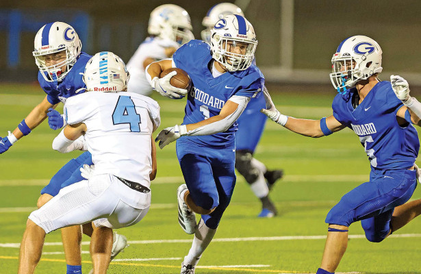 Erik Olivas runs for a large gain during Goddard’s rivalry win over the Eisenhower Tigers. Olivas had a big night following the loss of the Lions’ starting quarterback, helping them to a 36-28 win. Matt Buchar/Ginger Viking Fotos