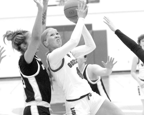 Goddard’s Presley Schmidt drives through a group of Newton defenders during last Friday’s win on winter homecoming night. Travis Mounts/TSnews