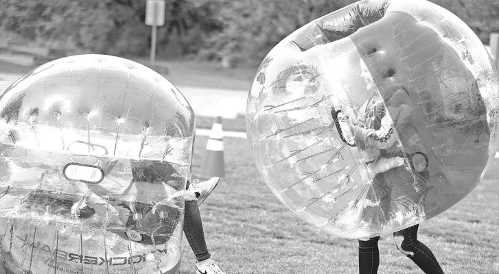 Taylor Burris, left, gets knocked to the ground by Jordan Burris as they play with bubble balls. Stephanie McKennon / TSnews