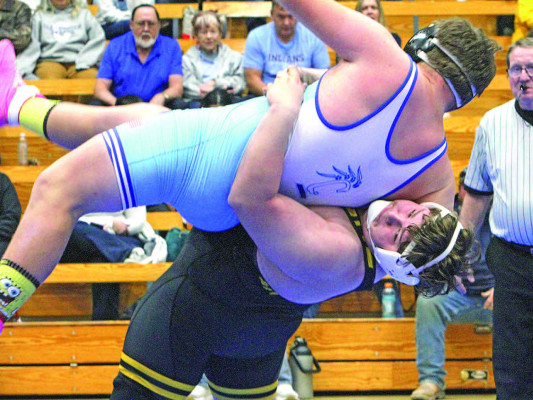 Campus High’s Remington Pugh lifts Clearwater’s Dallen Kanngiesser of Clearwater off the mat during their heavyweight match that decided the dual between the two neighboring schools. Travis Mounts/TSnews