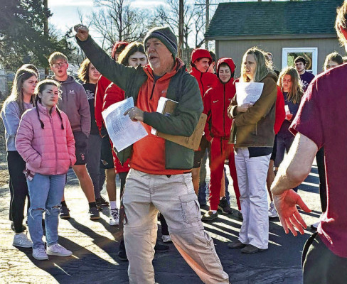 Instructor Chris Bellar leads students as they distribute prairie seed mix on a new area at the Conway Springs High School OWLS site. Contributed photo