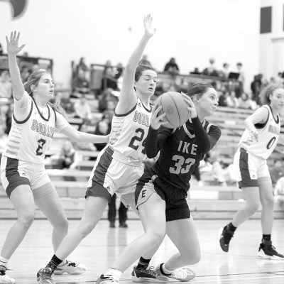 Goddard Lions defenders Sadie Bowyer and Lauryn Gordon try to keep Eisenhower’s Ella Friend out of the lane during last week’s rivalry game. Stephanie McKennon/TSnews