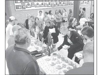 Teachers and staff at Cheney High School line up for ice cream, which was provided by the Cheney Chamber of Commerce. Each year, the Chamber hosts an ice cream social for educators before students return to class. Travis Mounts/TSnews