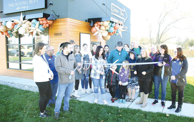 Christy Reeder cuts the ribbon during Saturday morning’s ribbon cutting at The Rusted Bean Coffee Co., which opened recently in Goddard. Members of the Goddard Chamber of Commerce hosted the ribbon-cutting event. Travis Mounts/TSnews