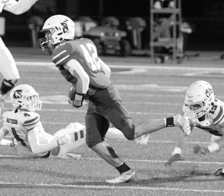 Colton Young shakes off a pair of tacklers and runs for a second-half touchdown during Cheney’s home playoff win over Concordia on Friday night. Travis Mounts/TSnews