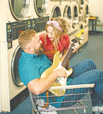Logan Mize and Jill Martin play around with a laundry cart while recording video at the Cheney Landromat last week. The couple has a new, five-song project coming out in August called “The Mizes.” The first song to be released, “Hitched Up,” will be available on July 28. Sydney Davidson/Contributed photo
