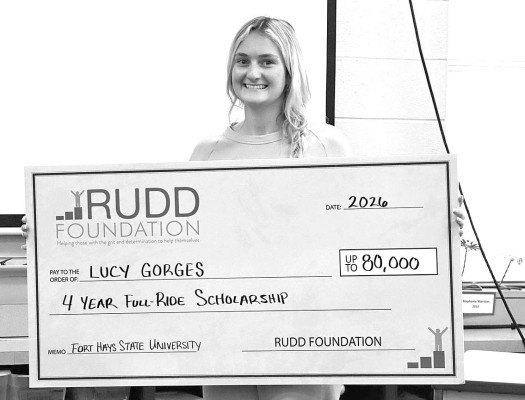 Cheney High School senior Lucy Gorges holds a simulated check after she was presented with the Rudd Foundation Scholarship last week at CHS. The $80,000 scholarship will cover her tuition, room and board, books, supplies and other costs at Fort Hays State University. Contributed photo