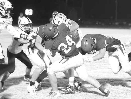 Cade Howell leads a group of tacklers in bringing down a Sterling runner. Conway Springs scored on the third play of the game en route to a blowout playoff win. Stephanie McKennon/TSnews