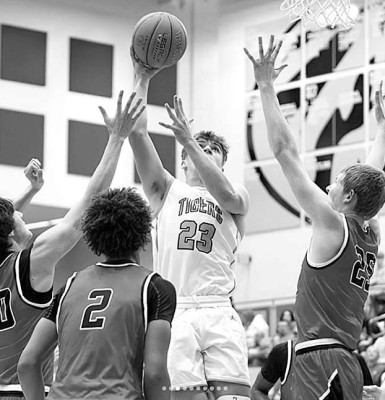 Derek Morgan shoots over a trio of Maize defenders during Eisenhower’s home game last Friday. The host Tigers lost to the Eagles. Matt Bucher/Ginger Viking Fotos