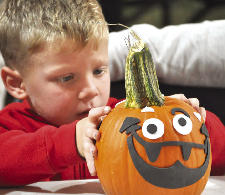 Jaxon Martinez puts the finishing touches on his pumpkin during the pumpkin decorating event at the Haysville Fall Festival on Saturday. Turn to Page A12 to see more photos from the festival. Paul Rhodes/TSnews