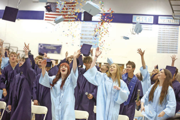 Stephanie McKennon and Jessica Reed/TSnews LEFT: Clearwater High School seniors celebrate the end of commencement on Sunday afternoon. ABOVE: Ryder Ragan is congratulated following graduation at Argonia High School.