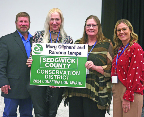 Ramona Lampe and Mary Oliphant receive a Sedgwick County Conservation Award that recognizes the work begun by their mother, Roberta Lampe. Stephanie McKennon/TSnews