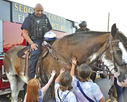 Rain moved out of the way before Goddard National Night Out took place last Friday. With the weather cooperating, a good crowd turned out for the annual event at Linear Park. Several children pet Keeper, a horse that is part of the Wichita Police Department. Subscribers can see additional photos online at tsnews.com. Dale Stelz/TSnews