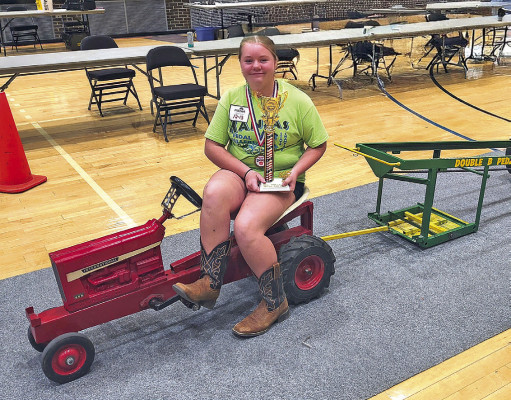 ABOVE: Ava Clouse poses at the The World’s Only Corn Palace. She finished fifth among 12-year-old girls. BELOW: Oaklynn Lutz competes in the National Kids Pedal Pull, where she placed 11th in the 10-year-old girls division. Contributed photo