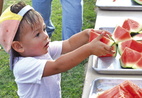Riely Wiebe helps himself to a piece of watermelon at the Goddard Independence Day celebration, which was held on Saturday night at the ball fields by Clark Davidson School. Many people turned out for free food, live music, a little softball, and the annual fireworks show. See more photos on Page B1. Subscribers can see a full photo album online at tsnews.com. Dale Stelz/TSnews