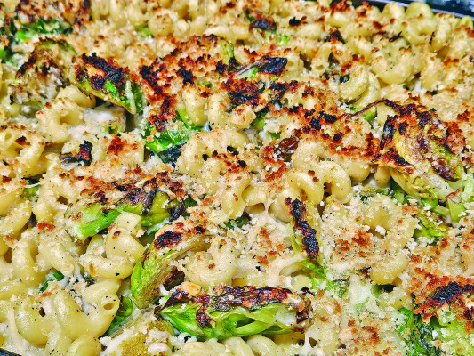 Brussels sprouts go from being a health food to a roasty compliment to melty rich cheeses in this decadent mac and cheese recipe.