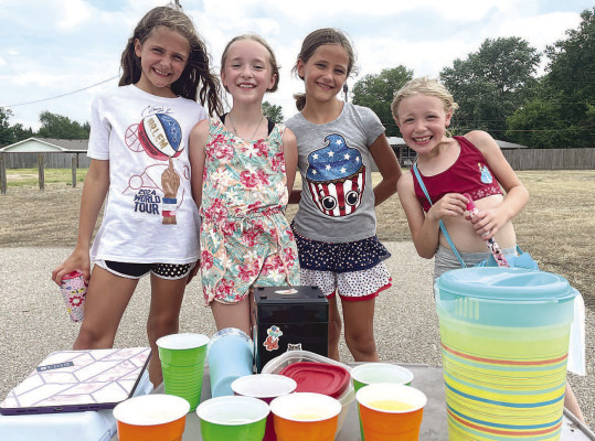 Saturday was a hot day for being outside, but the weather was perfect for running a lemonade stand. In Garden Plain, Jude Kampling, left, Emily Scranton, Olivia Kampling and Leona Scranton teamed up to offer drinks along Harry Street near the old Frosty Treat building. Travis Mounts/TSnews OPINION: When you see a lemonade stand, you buy lemonade. See Page B8.
