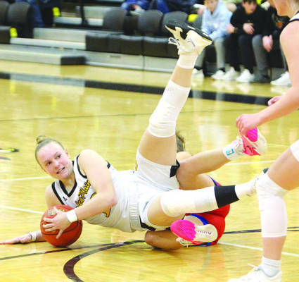 The Owls’ Jaden Stuhlsatz falls to floor while battling for the ball during Garden Plain’s game against Cheney last Friday. Travis Mounts/TSnews