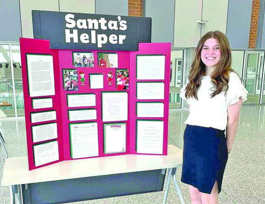 Julia Zoglmann poses in front of her STAR Event at the district competition Feb. 8. Zoglmann qualified through District to compete at State and then Nationals. Cardinal Times/Contributed photo