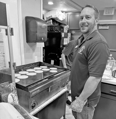 Goddard Lion Preston Black cooks up a batch of pancakes on Saturday at the Goddard Community Center. The Lions held their annual pancake, sausage and biscuits-and-gravy breakfast, which is one of their primary fundraisers and a popular community event. Contributed photo