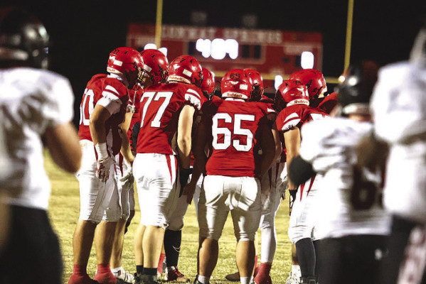 The Conway Springs Cardinals huddle before a play during last Friday’s win against the Plainville Cardinals. Conway Springs is now one win away from returning to the Class 1A State championship. Stephanie McKennon/TSnews