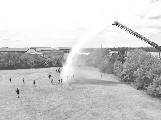Last Friday, a crew from Sedgwick County Fire District 1 Station 34 took part in St. Celicia Catholic Church's afternoon church camp, spraying water from an aerial unit. The department used a drone to capture images of camp participants having fun and cooling off. Contributed photo/Sedgwick County Fire District 1