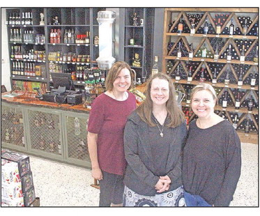 Sisters Rachel Sponsel, left, Sarah Truman and Beth Golay – the daughters of the late Phil Becker, Garden Plain's longtime barber – have opened Phil's Liquor cabinet in the space that he occupied for many years. The remodeled interior includes his old barber pole. Travis Mounts/TSnews