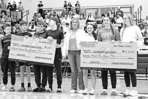 The Tiger Nation Booster Club recently donated $56,000 to support athletics and activities for students at two schools in the Goddard School District. The booster club made a donation of $44,500 to Eisenhower High School, and a donation of $11,500 to Eisenhower Middle School. A check presentation was made on Feb. 10 at winter homecoming, when the EHS Tigers basketball teams hosted the Goddard Lions. Matt Buchar/Ginger Viking Fotos