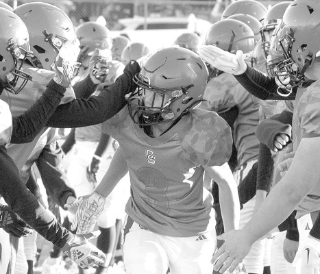 Eli Howard runs through a line of teammates as the Conway Springs Cardinals are introduced before the start of Friday’s home playoff game. The Cardinals easily defeated Stanton County. Conway Springs will be back at home this Friday for a 7 p.m. game with Sterling, a team that Conway Springs faced in the regular season. Travis Mounts/Tsnews