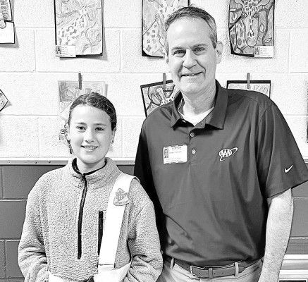 Ellie Reid is pictured with Shawn Steward of AAA Kansas. Reid, a Nelson Elementary fifth-grade student, has been named as the AAA Outstanding Safety Patroller of the Year award. Contributed photo