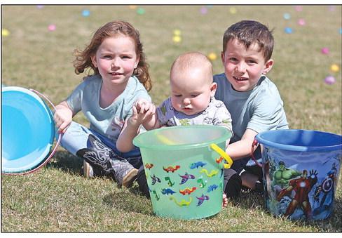 Siblings Ezekia, Lilith and Zarel Uhl sit together before the start of the Haysville Easter egg hunt, which was held Sunday afternoon at Dorner Park. Roughly 6,000 Easter eggs were put out this year. See many more photographs online at www.tsnews.com. Stephanie McKennon/TSnews