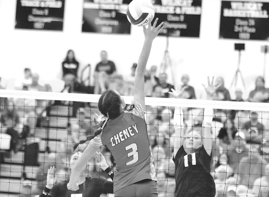 Reese Hedstrom tries a kill against a pair of Trinity Academy defenders. Cheney beat Trinity in two sets in the title match, earning a trip back to 3A State. Stephanie McKennon/TSnews