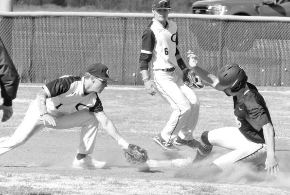 Eisenhower’s Carter Pabst slides underneath the tage of Campus short stop Camden Schroeder during the first game of last Friday’s doubleheader in Haysville. More game photos will be posted at www.tsnews.com. Travis Mouints/TSnews