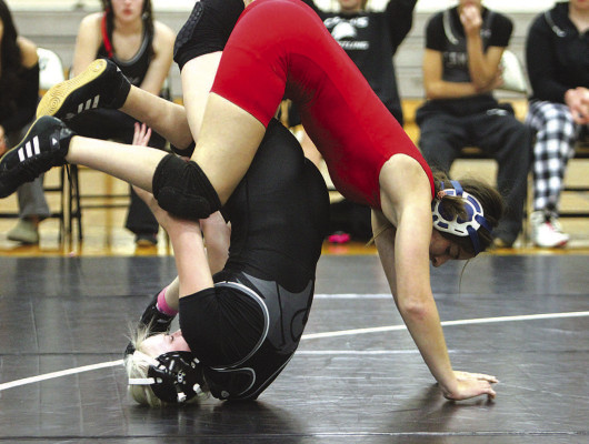 Campus’ Kalley Hough and Cheney’s Peyton McClellan battle for control during their match last Thursday in Haysville. McClellan won the match, while Hough battled through an unknown injury suffered during the match. The teams split two matches. Campus won the others with Cheney being open at most weights. Travis Mounts/TSnews