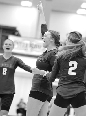 ABOVE: The Goddard Lions celebrate a point during their home triangular last week. BELOW: Riley Schoen goes up for a block as the rest of the Lions play defense during a match with Salina Central. Subscribers can see more photos from this and other sports events online at tsnews.com. Stephanie McKennon/TSnews