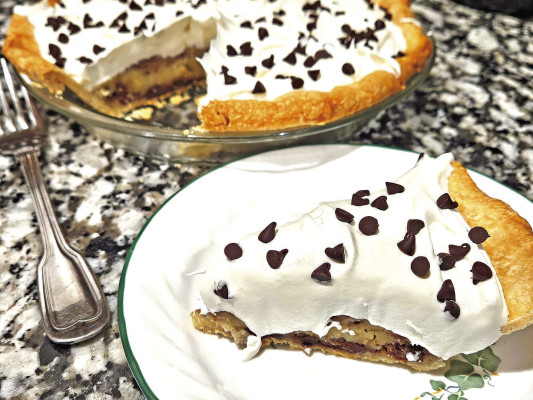 Chocolate chip pie takes the flavors of a good chocolate chip cookie and puts it into pie form, featuring little pockets of chocolate throughout every bite and a nice, thick layer of whipped topping to cap it off.