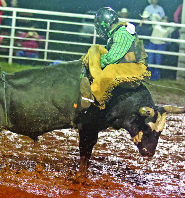 A cowboy gets turned around during a bull ride Sunday night at the 14th annual Bronc Kraft Memorial Rodeo, held on Saturday and Sunday in Conway Springs. The annual rodeo memorializes Bronc Kraft of the Kraft Rodeo Company, who died in a crash coming to the Labor Day Weekend rodeo when it was still held in Argonia. See more photographs on Page A10. Stephanie McKennen/TSnews