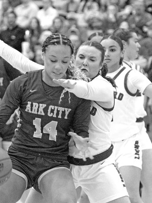 Chloe Hartzler of Goddard plays tight defense on an Arkansas City player during last Friday’s homecoming basketball game. Travis Mounts/TSnews