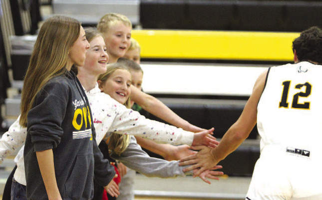 Eli Eck high fives young fans during introductions at last Thursday’s home game in Garden Plain. Travis Mounts/TSnews