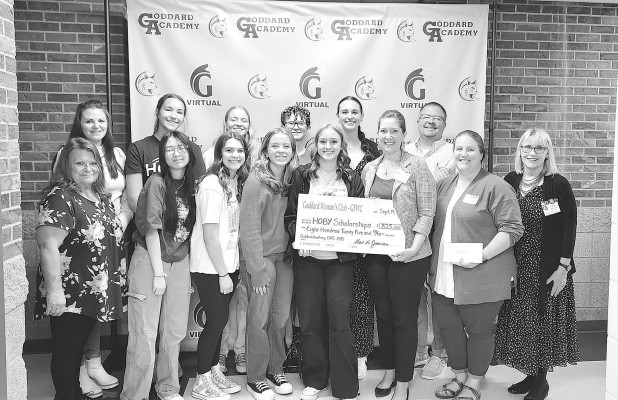 Goddard Academy student Emma Schmidt and Goddard Woman’s Club member Liz Hamor hold the check representing $825 for three scholarships. Contributed photo