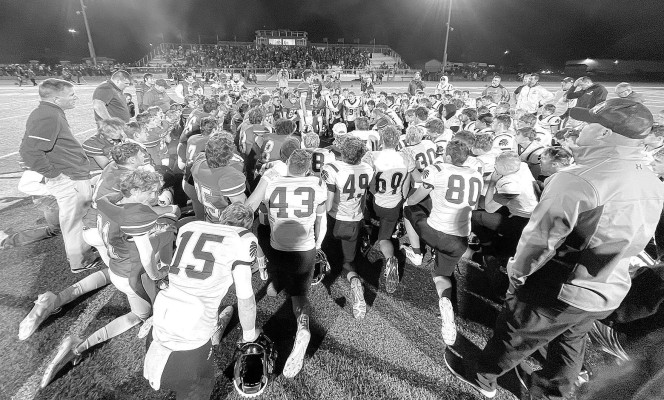 Cheney and Andale players come together in prayer after the team’s first game this year in October. Cheney players encouraged all of their opponents to share a prayer after their games. Travis Mounts/TSnews