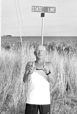 Rick Wulf stops for a photo at the Kansas-Colorado state line. He ran roughly 544 miles from Cheney to Denver’s Tennyson Center for Children. Contributed photo