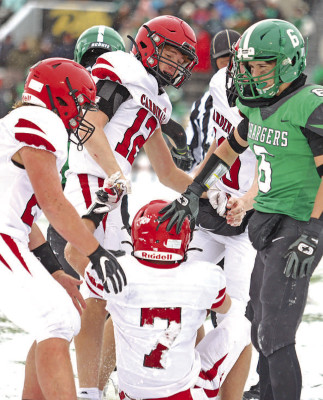 Players from both teams give a hand to Isaac Winter (7) after a play during Conway Springs’ State championship win over Jefferson County North. Stephanie McKennon/TSnews