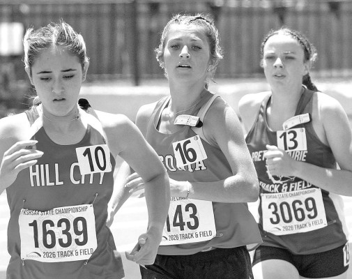 Bailey Haines, center, runs in the 1600 meters at last weekend’s State track and field meet. She also competed for Argonia in the 800 meters. Travis Mounts/TSnews