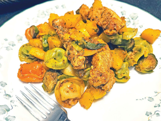 Fall chicken and vegetables features all the flavors of the season with sweet butternut squash, earthy Brussels sprouts and plenty of garlic, along with cheesy tortellini and paprika-seasoned chicken.
