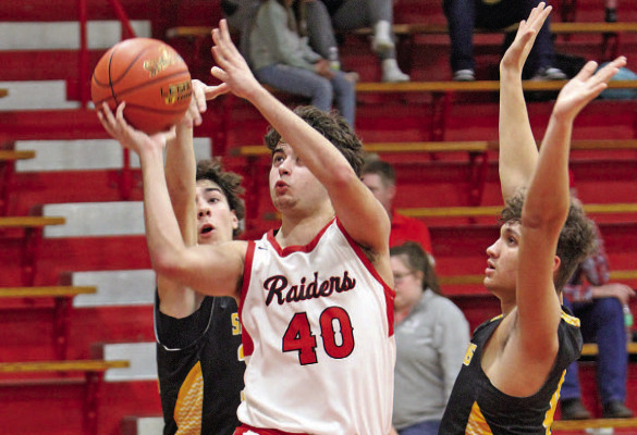 ABOVE: Manuel Benavides, a foreign exchange student from Spain, puts up a shot during a home basketball game earlier this year. He was a significant contributor for the Raiders. BELOW: Silas Boetcher runs in a track meet this spring. The German student also was part of the football and basketball teams. Travis Mounts/TSnews