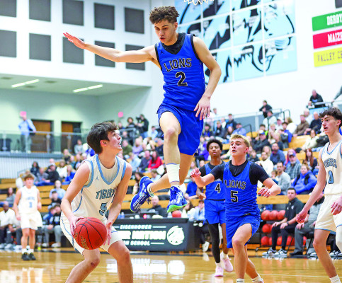 The Tigers’ Owen Stanberry uses a fake to get the Lions’ Brysyn Warren into the air during last Friday’s game at Eisenhower. The Tigers came away with a 21-point win. Matt Bucher/Ginger Viking Fotos
